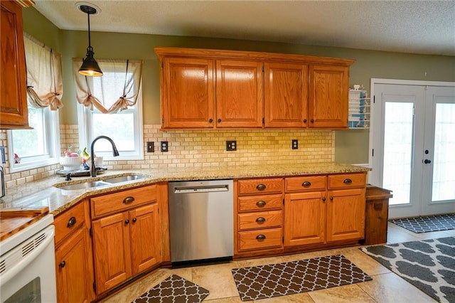 101 Shasta Daisy Dr, Smithville, MO 64089 - kitchen with stainless steel dishwasher, healthy amount of natural light, brown cabinetry, and a textured ceiling
