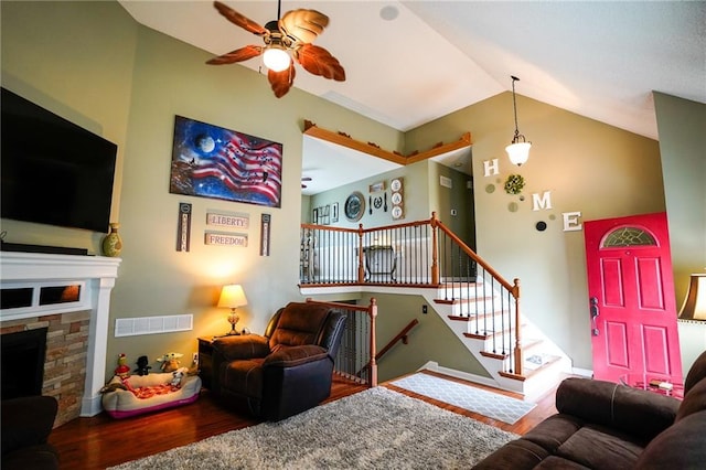 101 Shasta Daisy Dr, Smithville, MO 64089 - living area with wood finished floors, ceiling fan, lofted ceiling, a stone fireplace, and stairs