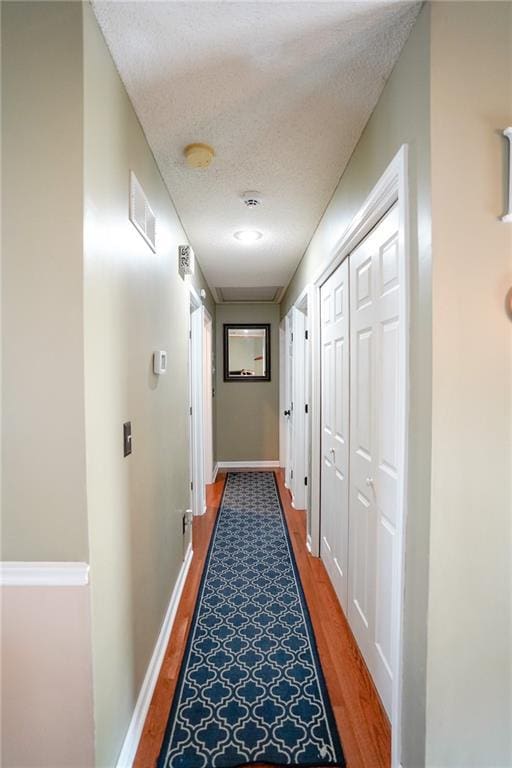 101 Shasta Daisy Dr, Smithville, MO 64089 - hallway featuring light wood-style flooring and a textured ceiling