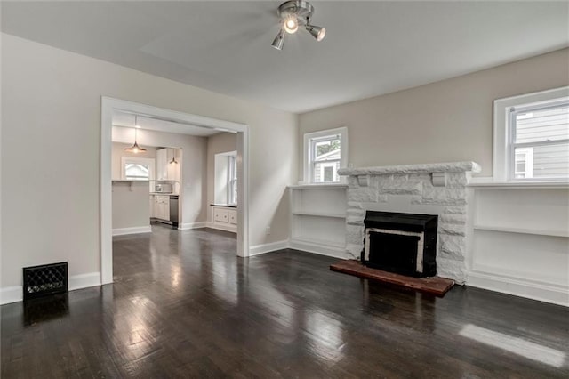 826 W 75th St, Kansas City, MO 64114 - unfurnished living room featuring wood finished floors, a fireplace, and a ceiling fan