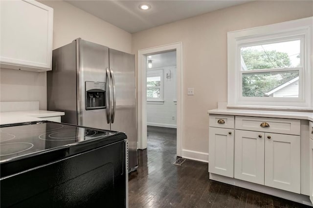 826 W 75th St, Kansas City, MO 64114 - kitchen with black electric range, dark wood finished floors, white cabinetry, light countertops, and recessed lighting