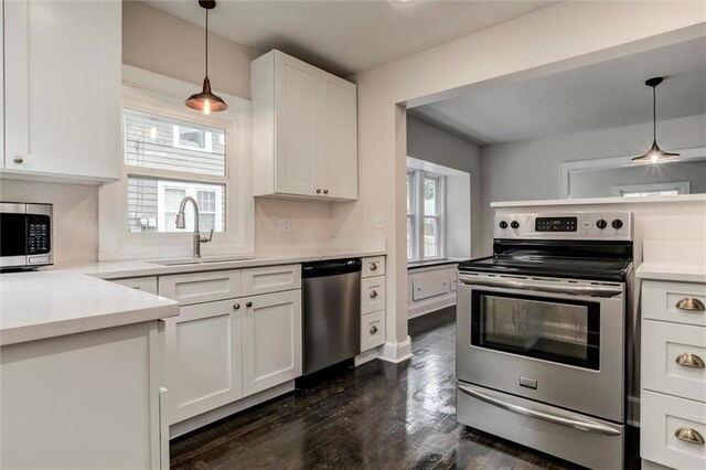 826 W 75th St, Kansas City, MO 64114 - kitchen featuring appliances with stainless steel finishes, white cabinets, and dark wood finished floors