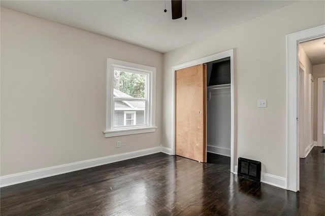826 W 75th St, Kansas City, MO 64114 - unfurnished bedroom featuring dark wood finished floors, a closet, and a ceiling fan