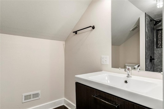 826 W 75th St, Kansas City, MO 64114 - bathroom featuring lofted ceiling, vanity, and a shower