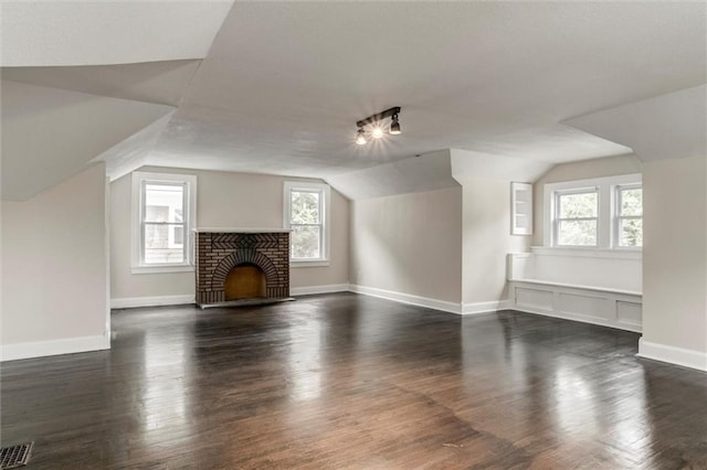 826 W 75th St, Kansas City, MO 64114 - unfurnished living room with lofted ceiling, dark wood-style flooring, and a fireplace