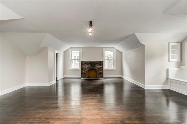 826 W 75th St, Kansas City, MO 64114 - additional living space with vaulted ceiling, dark wood-type flooring, and a fireplace