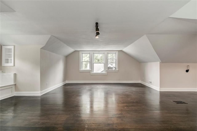 826 W 75th St, Kansas City, MO 64114 - bonus room featuring dark wood finished floors and vaulted ceiling