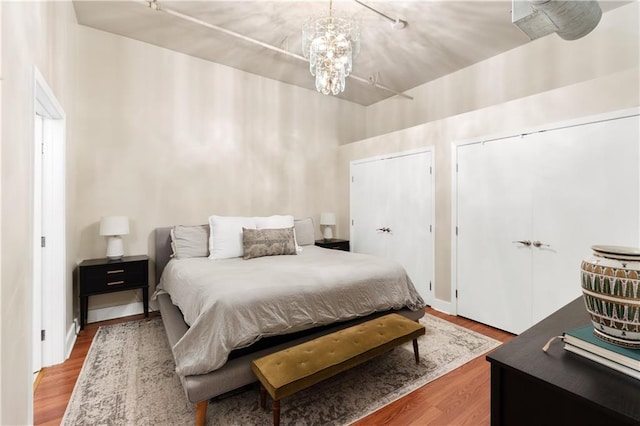 200 Main St Unit 509, Kansas City, MO 64105 - bedroom with wood finished floors, multiple closets, and a chandelier