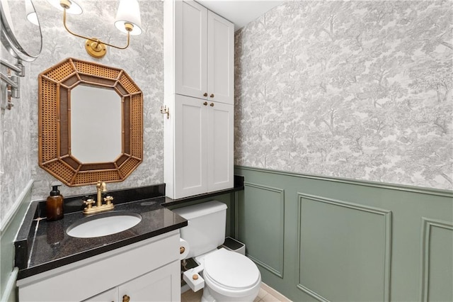 200 Main St Unit 509, Kansas City, MO 64105 - half bathroom featuring wallpapered walls, vanity, and wainscoting