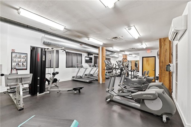 200 Main St Unit 509, Kansas City, MO 64105 - exercise room featuring a wall unit AC and baseboards