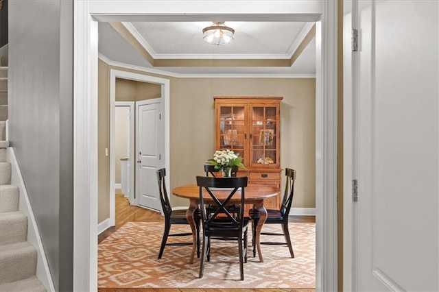 5814 Aminda St, Shawnee, KS 66226 - dining space with a tray ceiling, stairway, light wood-type flooring, and crown molding