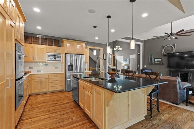 5814 Aminda St, Shawnee, KS 66226 - kitchen featuring light brown cabinets, stainless steel appliances, light wood finished floors, open floor plan, and recessed lighting