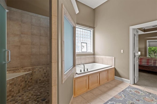 5814 Aminda St, Shawnee, KS 66226 - bathroom featuring tile patterned flooring, a bath, a stall shower, and connected bathroom