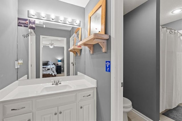 5814 Aminda St, Shawnee, KS 66226 - ensuite bathroom with vanity, ceiling fan, tile patterned flooring, and a textured ceiling