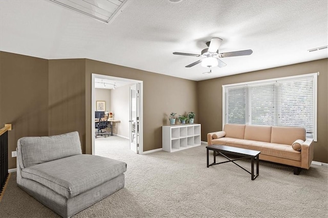 5814 Aminda St, Shawnee, KS 66226 - carpeted living area featuring a ceiling fan and a textured ceiling