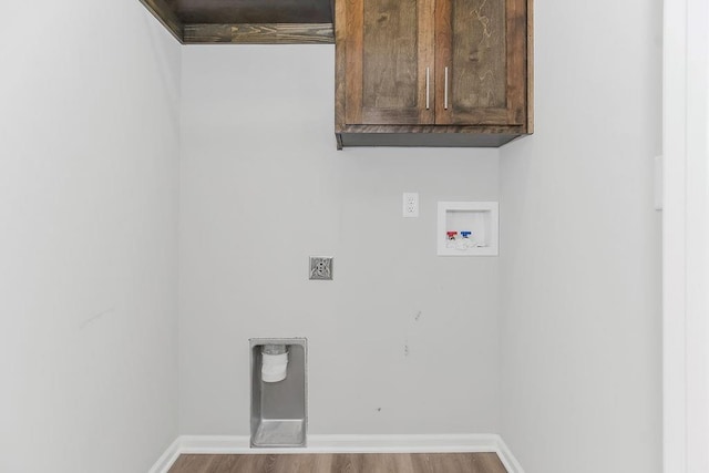 21119 E 8th St S, Independence, MO 64056 - laundry room with washer hookup, cabinet space, wood finished floors, and hookup for an electric dryer