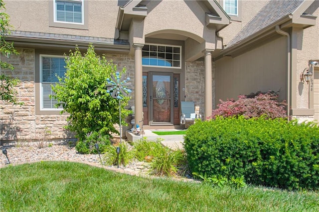 9624 N Arlington Ave, Kansas City, MO 64158 - doorway to property with stone siding, stucco siding, and a shingled roof