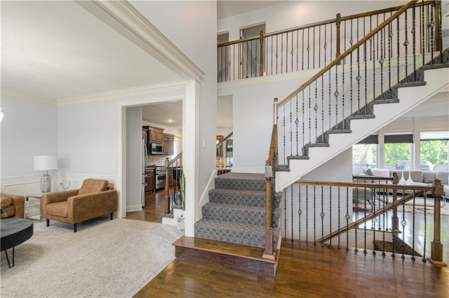 9624 N Arlington Ave, Kansas City, MO 64158 - stairs featuring wood finished floors and crown molding