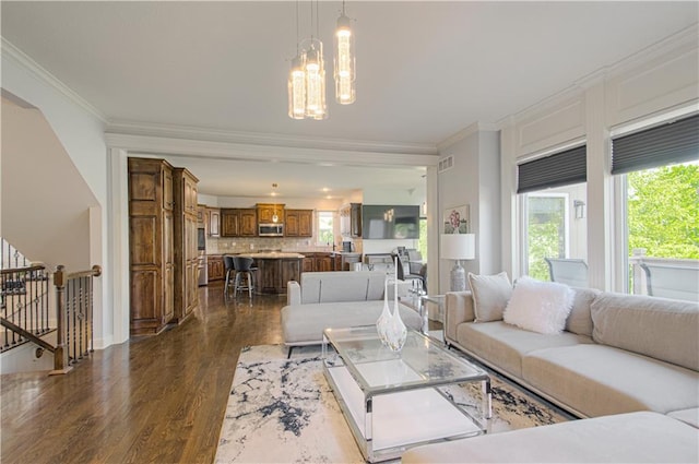 9624 N Arlington Ave, Kansas City, MO 64158 - living room featuring wood finished floors, healthy amount of natural light, crown molding, and a chandelier
