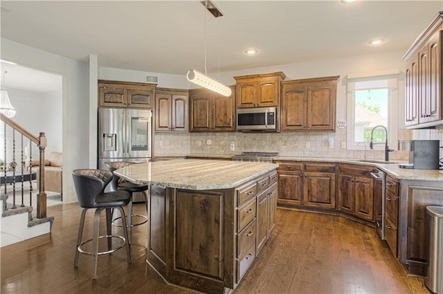 9624 N Arlington Ave, Kansas City, MO 64158 - kitchen with stainless steel appliances, dark wood finished floors, decorative backsplash, and recessed lighting