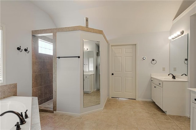9624 N Arlington Ave, Kansas City, MO 64158 - full bathroom featuring a garden tub, vanity, a walk in shower, lofted ceiling, and tile patterned flooring