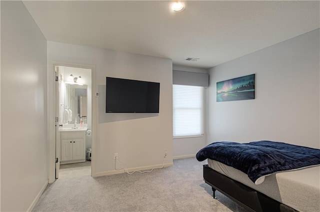 9624 N Arlington Ave, Kansas City, MO 64158 - bedroom with light carpet and connected bathroom
