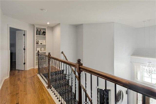 9624 N Arlington Ave, Kansas City, MO 64158 - hallway with an upstairs landing, a chandelier, light wood-style floors, built in features, and recessed lighting