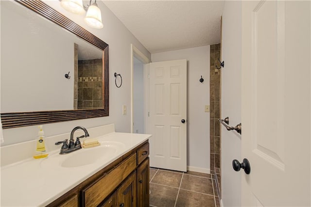 9624 N Arlington Ave, Kansas City, MO 64158 - full bathroom featuring vanity, a textured ceiling, and tile patterned flooring