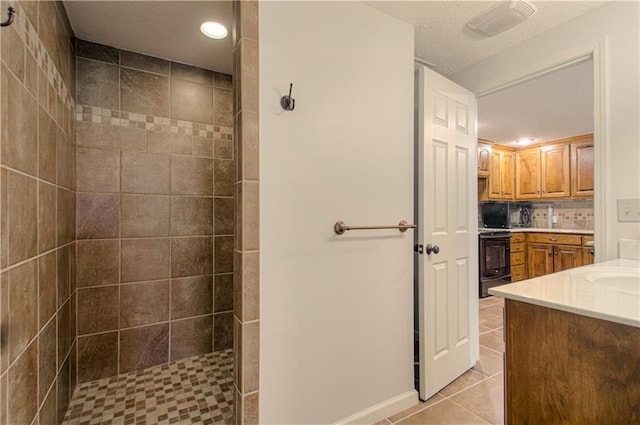 9624 N Arlington Ave, Kansas City, MO 64158 - full bath featuring vanity, tile patterned flooring, walk in shower, recessed lighting, and tasteful backsplash