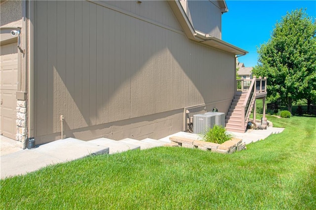 9624 N Arlington Ave, Kansas City, MO 64158 - view of home's exterior with a yard, stairs, and a deck