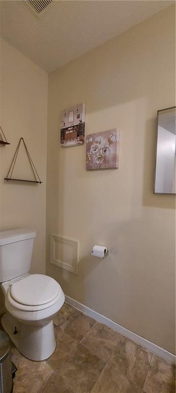 1431-33 E Penrose Ln, Olathe, KS 66062 - half bathroom featuring toilet and baseboards
