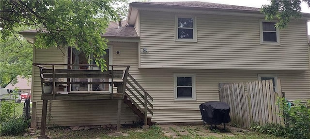 1431-33 E Penrose Ln, Olathe, KS 66062 - back of house featuring stairway, a shingled roof, and a wooden deck