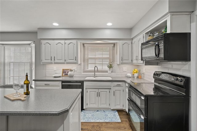 9805 W 121st Ter, Overland Park, KS 66213 - kitchen with black appliances, tasteful backsplash, dark wood-style floors, white cabinets, and recessed lighting