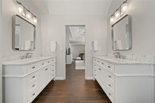 9805 W 121st Ter, Overland Park, KS 66213 - full bath featuring hardwood / wood-style flooring, two vanities, and ensuite bath
