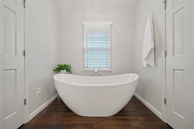 9805 W 121st Ter, Overland Park, KS 66213 - bathroom with a freestanding tub and wood finished floors