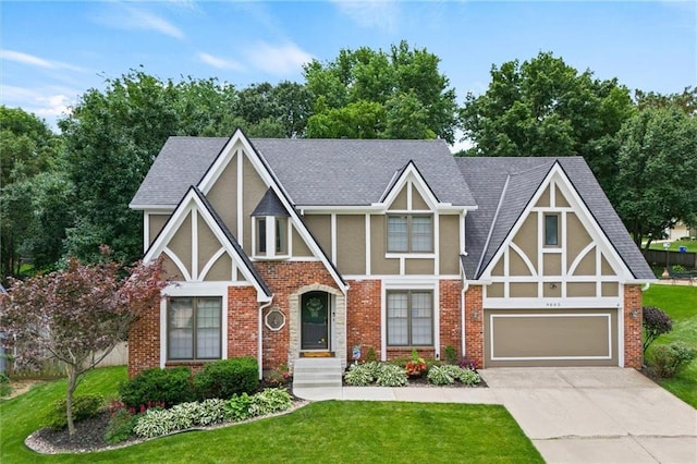 9805 W 121st Ter, Overland Park, KS 66213 - english style home with stucco siding, concrete driveway, a front lawn, and brick siding