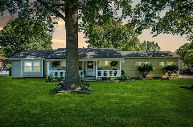 1934 E Mechanic Ave, Independence, MO 64050 - view of front facade with covered porch and a front lawn