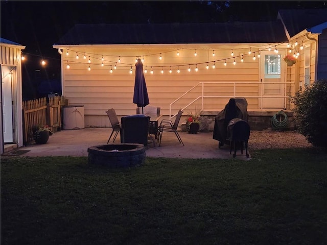 1934 E Mechanic Ave, Independence, MO 64050 - back of house at night featuring a fire pit and a patio