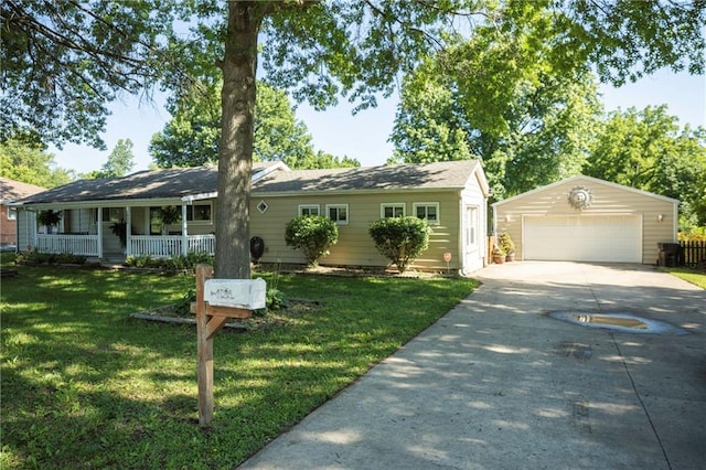 1934 E Mechanic Ave, Independence, MO 64050 - ranch-style house with a garage, an outbuilding, a front lawn, and a porch