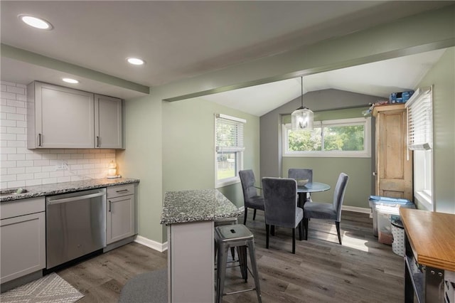 1934 E Mechanic Ave, Independence, MO 64050 - kitchen featuring dishwasher, dark wood finished floors, lofted ceiling, backsplash, and a breakfast bar