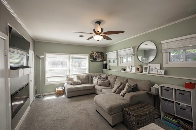 1934 E Mechanic Ave, Independence, MO 64050 - living area featuring ceiling fan, plenty of natural light, carpet flooring, a glass covered fireplace, and ornamental molding