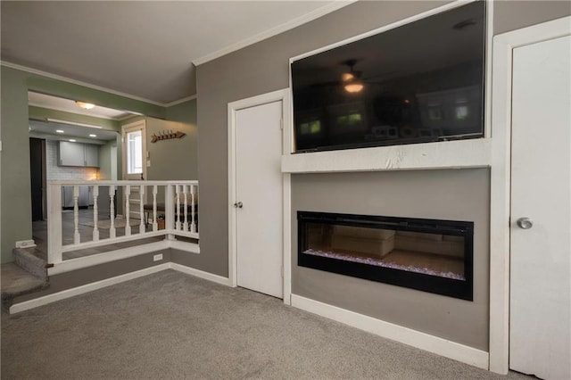 1934 E Mechanic Ave, Independence, MO 64050 - unfurnished living room featuring a glass covered fireplace, crown molding, carpet, and ceiling fan