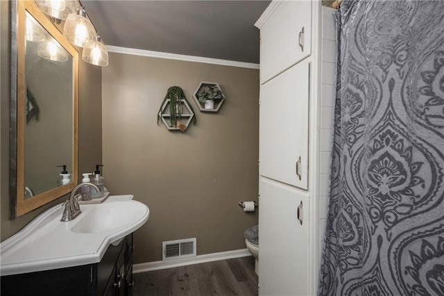 1934 E Mechanic Ave, Independence, MO 64050 - bathroom featuring vanity, ornamental molding, wood finished floors, and a shower with curtain