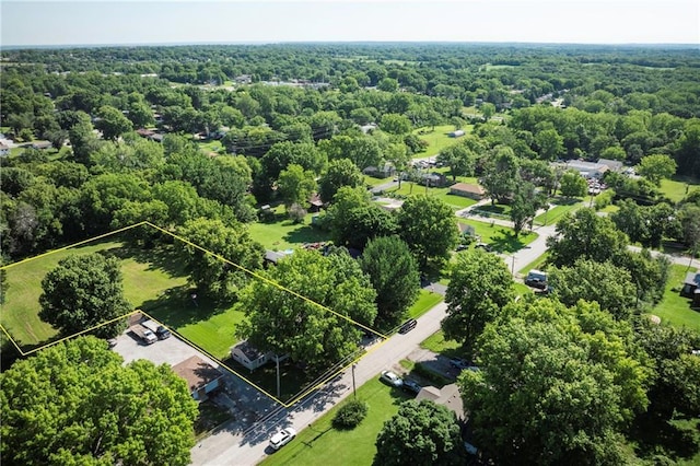 1934 E Mechanic Ave, Independence, MO 64050 - aerial view of property and surrounding area with property boundaries highlighted and a heavily wooded area