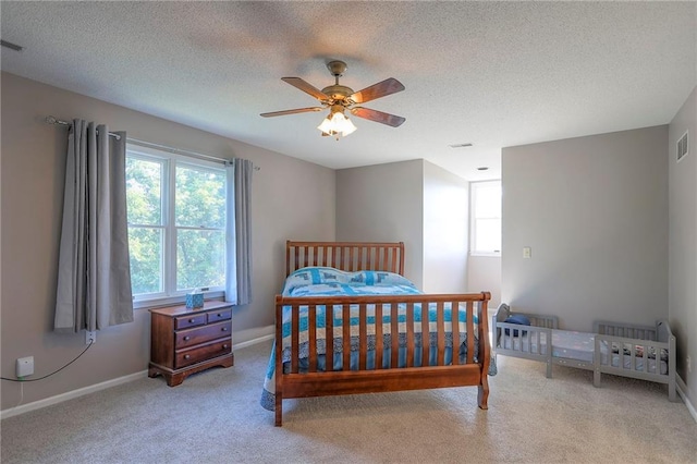 14043 170th St, Bonner Springs, KS 66012 - carpeted bedroom featuring multiple windows, a textured ceiling, and a ceiling fan