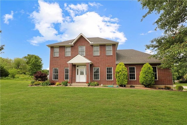 1503 Nottingham Dr, Warrensburg, MO 64093 - colonial house featuring a front lawn, brick siding, and a shingled roof