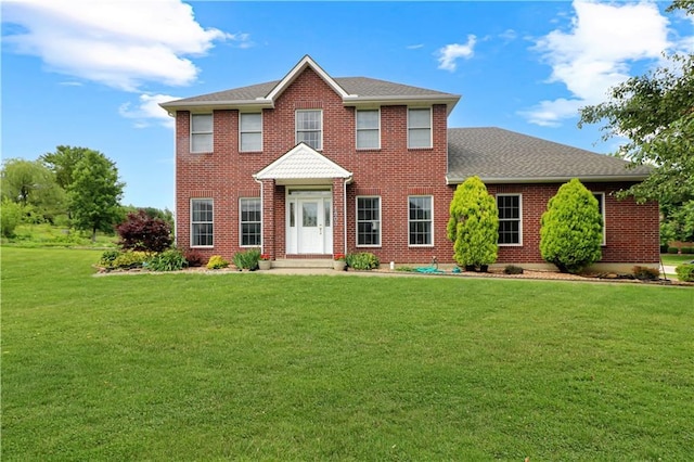 1503 Nottingham Dr, Warrensburg, MO 64093 - colonial inspired home featuring a front lawn, brick siding, and a shingled roof