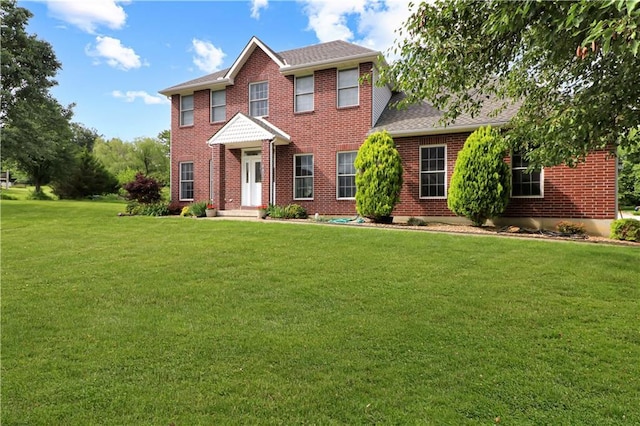 1503 Nottingham Dr, Warrensburg, MO 64093 - colonial inspired home with brick siding, a front yard, and a shingled roof