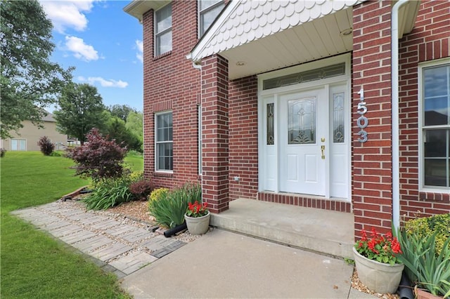 1503 Nottingham Dr, Warrensburg, MO 64093 - view of exterior entry featuring brick siding and a lawn