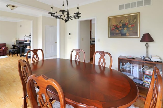 1503 Nottingham Dr, Warrensburg, MO 64093 - dining room with a chandelier and wood finished floors